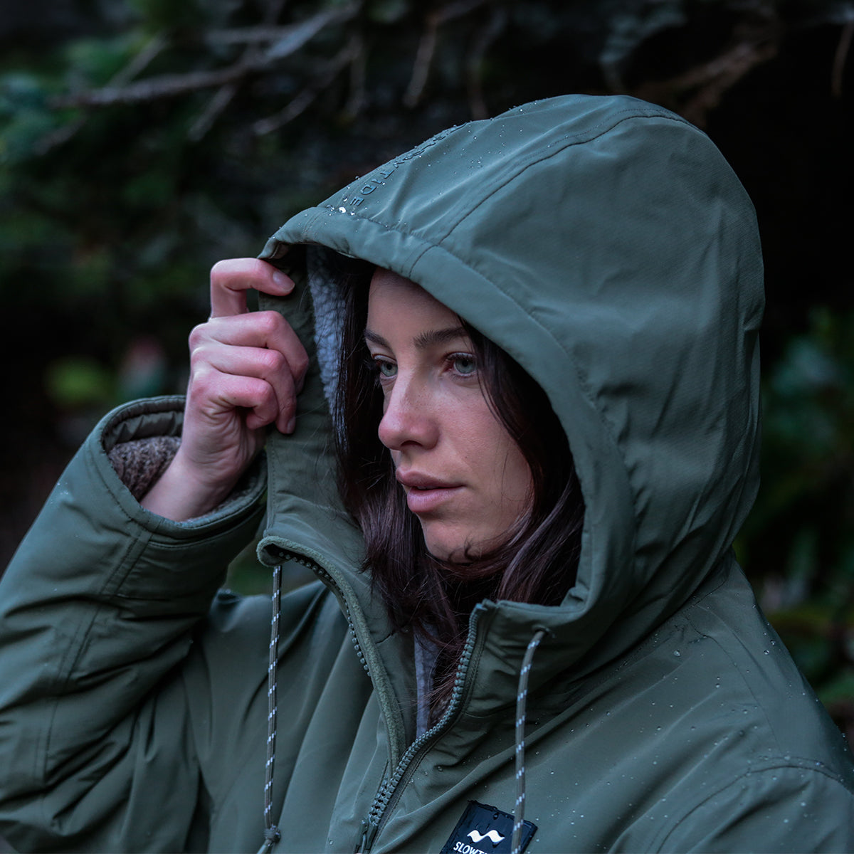 Green all-weather parka with insulated lining and waterproof hood.