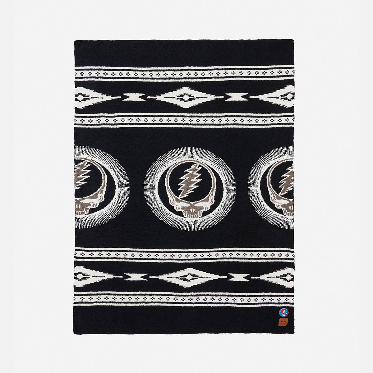 Throw blanket with skull, lightning bolt, and geometric patterns in black and white.