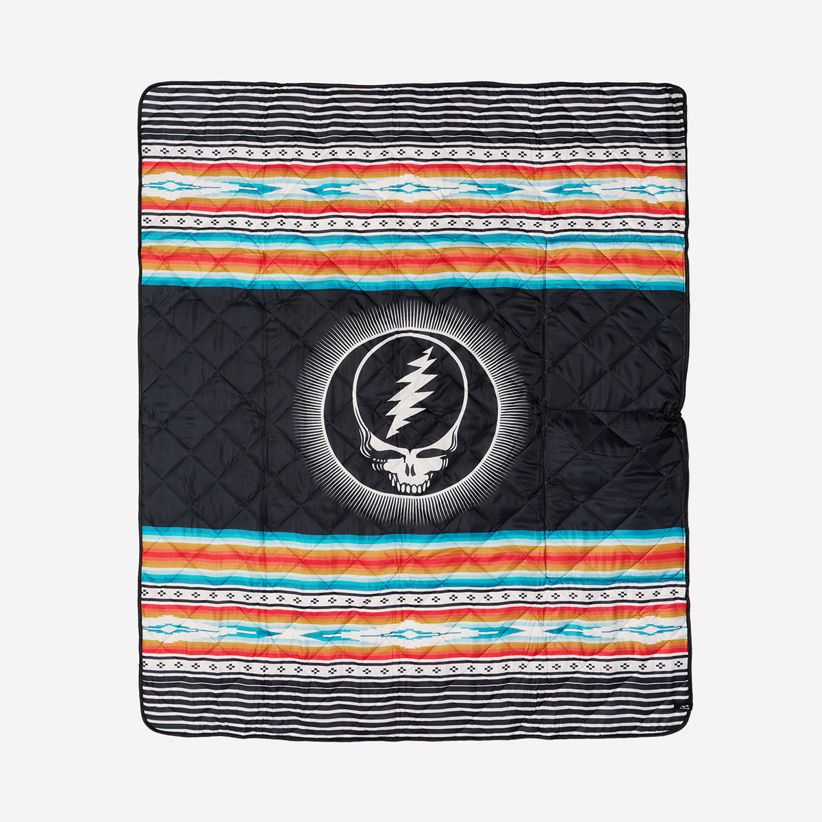 Picnic blanket with colorful stripes and central skull logo.
