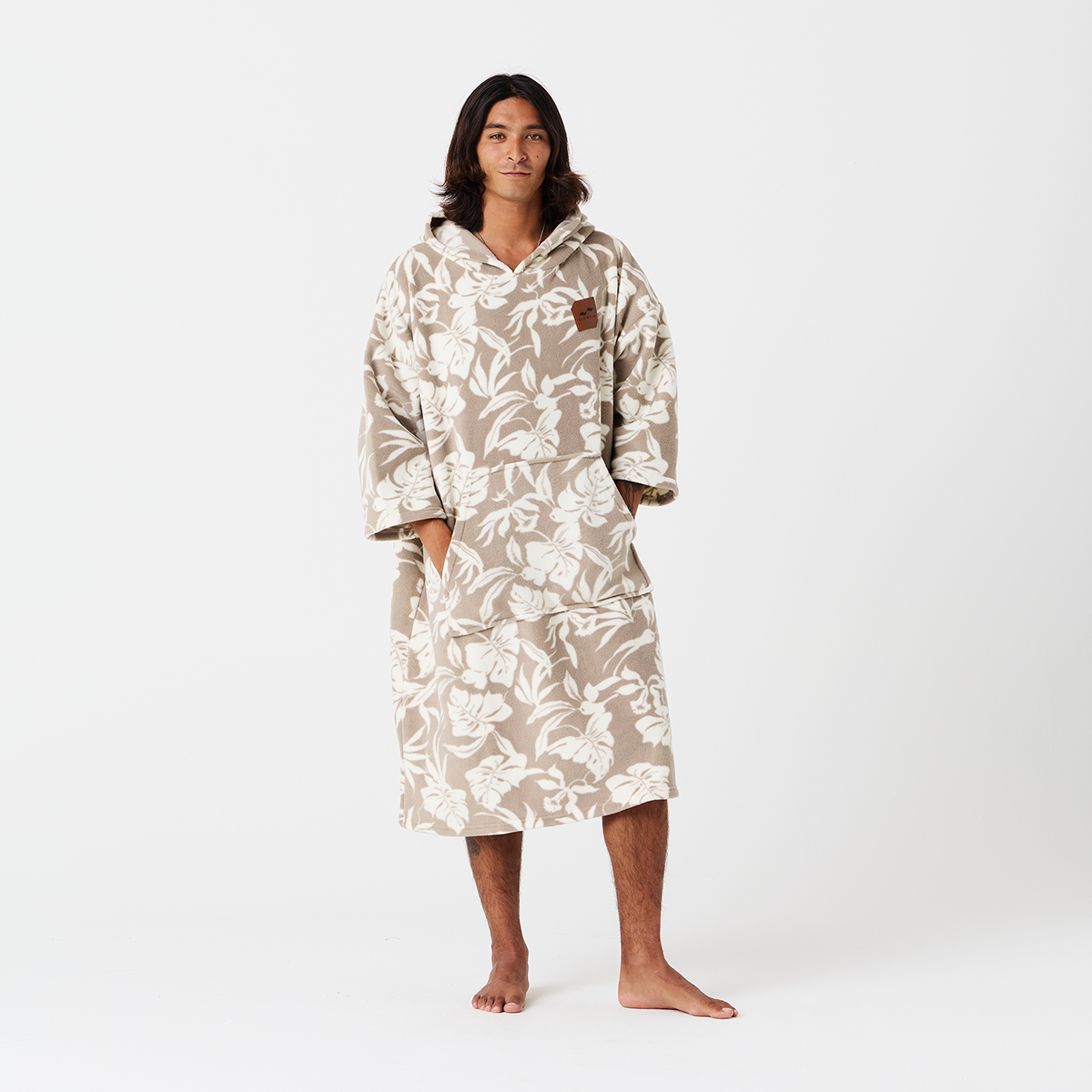 Fleece poncho with beige and white floral pattern.