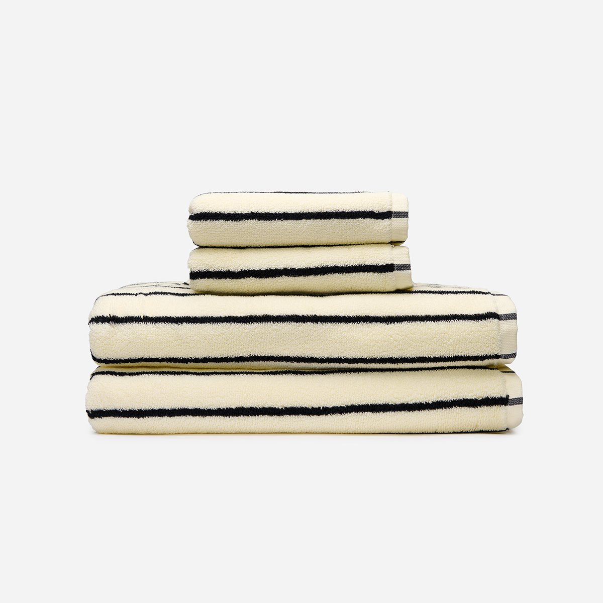 Cotton bath towels, cream with black stripes, stacked.