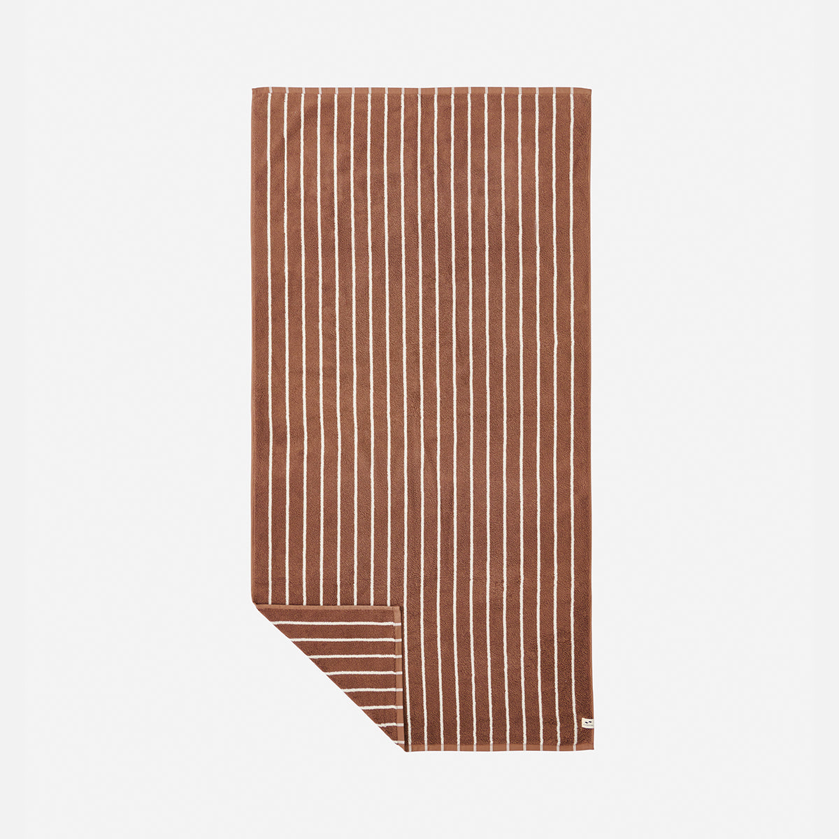 Bath towel, plush material, vertical white stripes with corner revealing horizontal stripes.