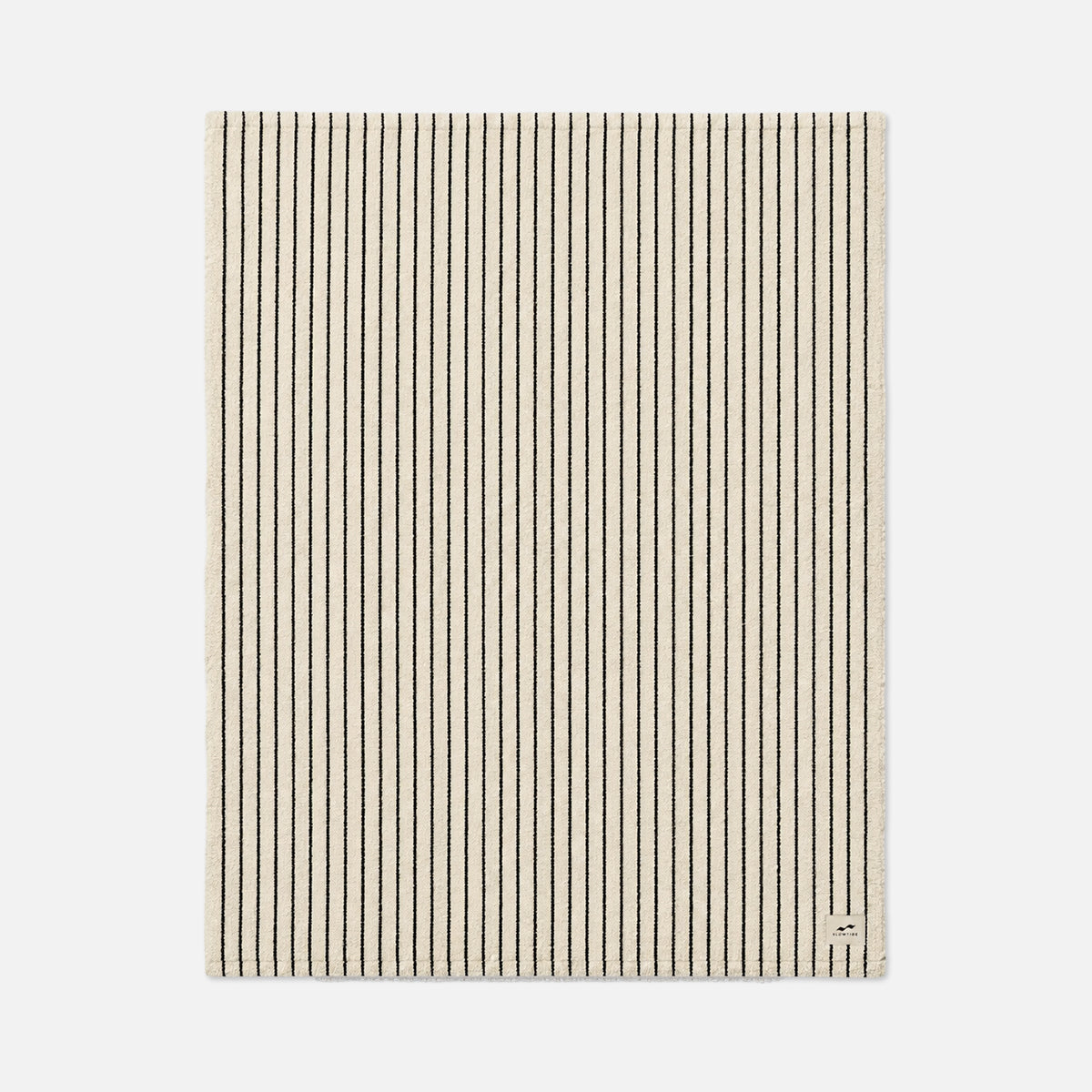 Beige rectangular rug with thin black stripes, suitable for layering with blankets.