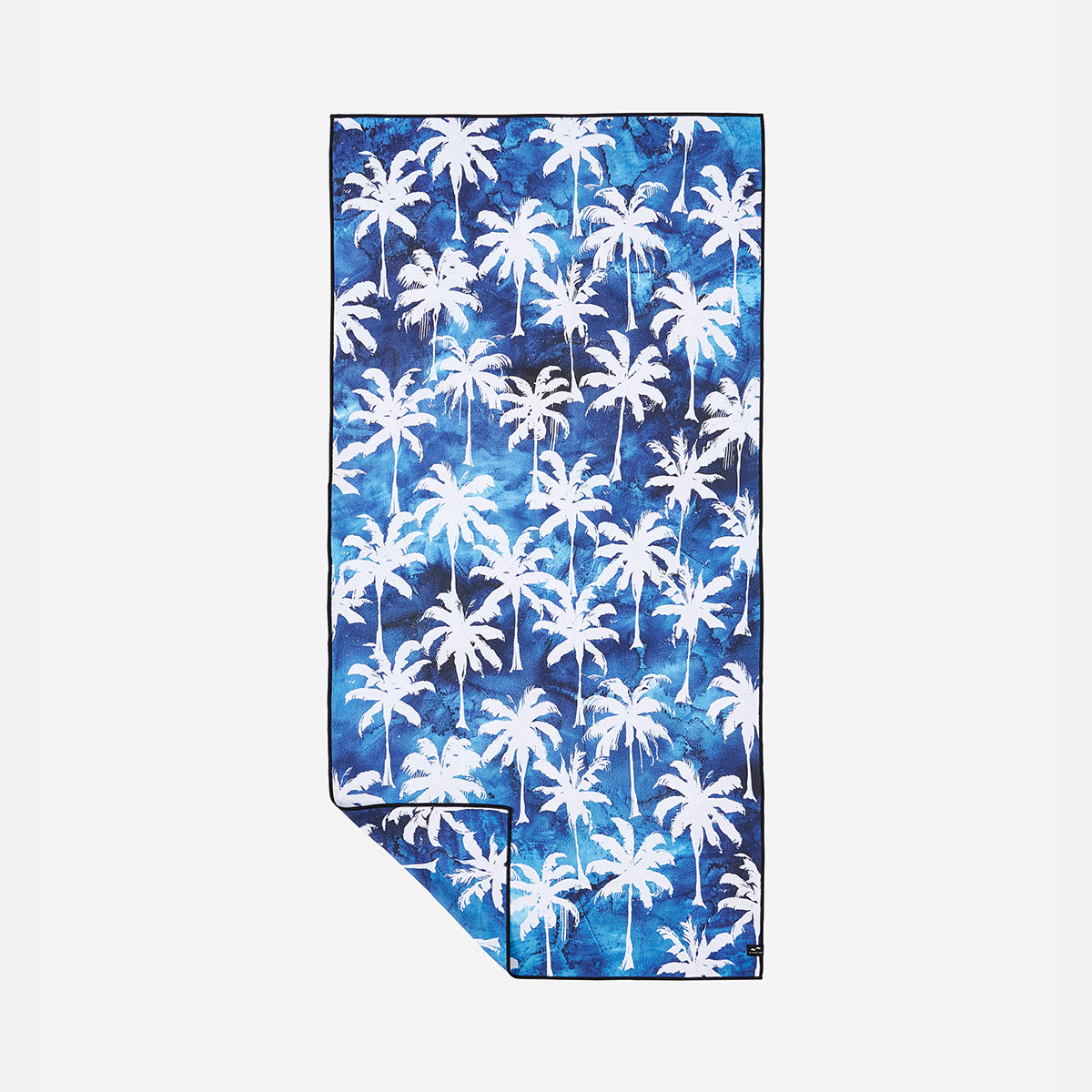 Towel, lightweight blue tie-dye with white palm tree pattern, one corner folded.