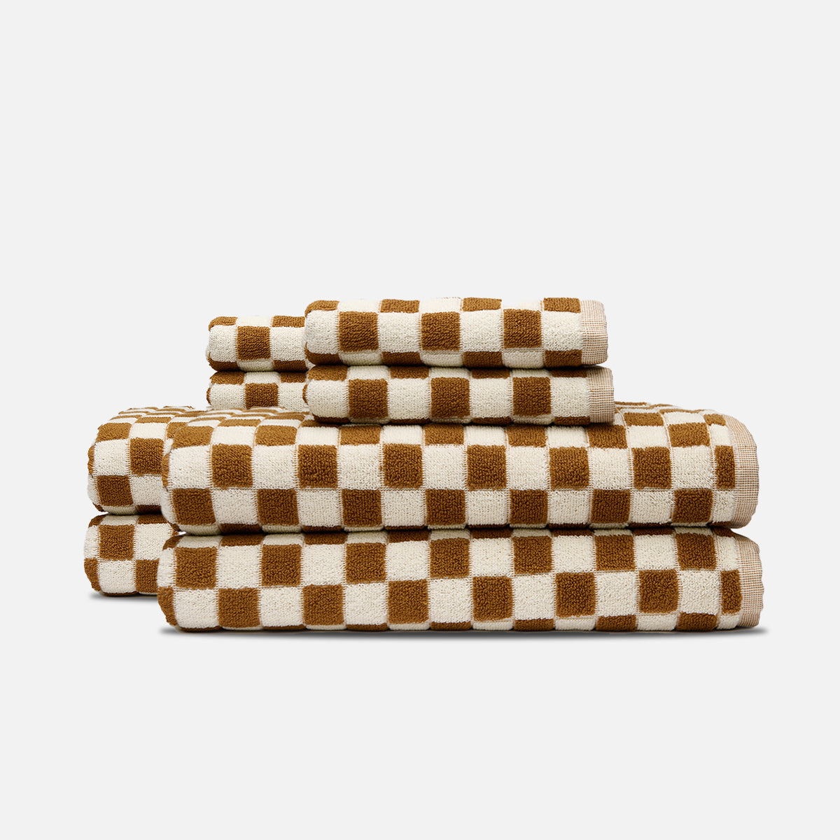 Towels with brown and white checkerboard pattern, stacked neatly.