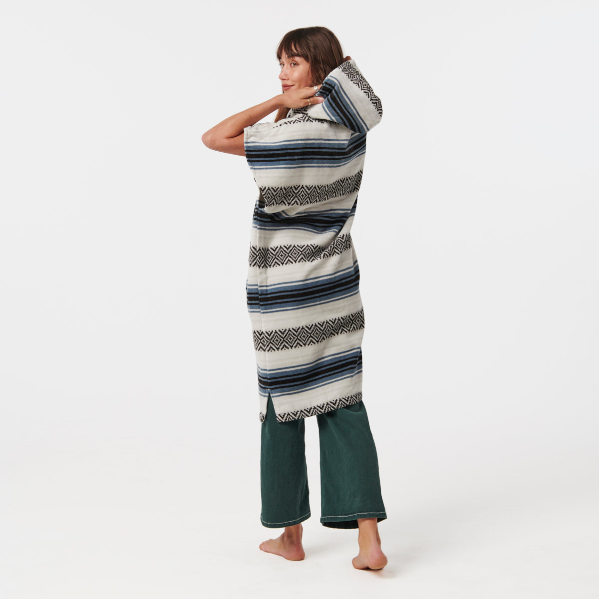 Hooded striped cotton towel poncho and green pants, absorbent material shown together.