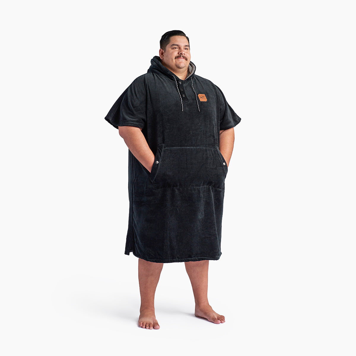 Black hooded cotton terry changing poncho with front pocket.