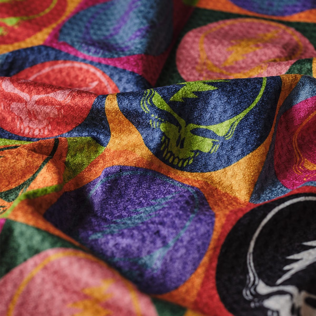 Quick-dry kitchen towel featuring colorful circles with skull and lightning bolt patterns.