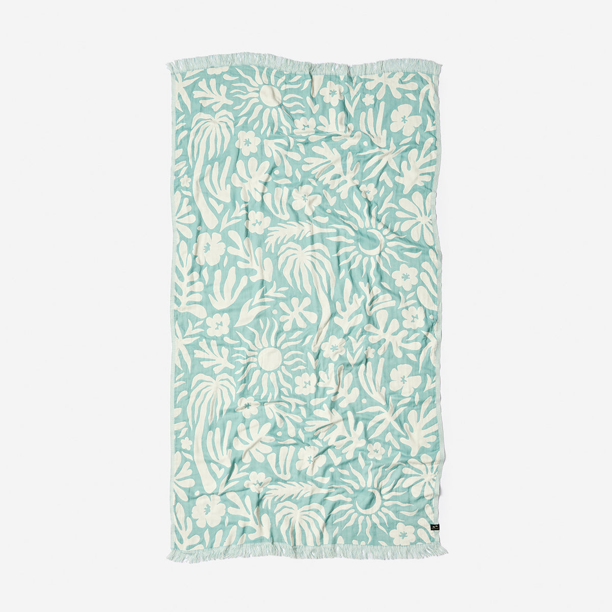 Turkish towel with tropical floral and leaf pattern, lightweight cotton, fringed edges.