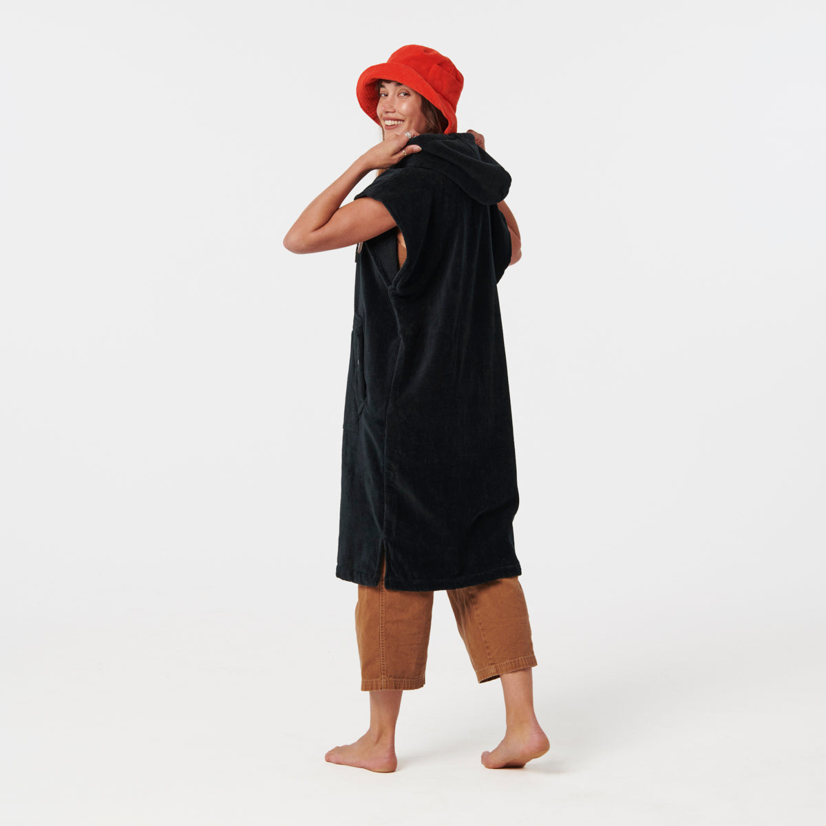 Black hooded changing poncho with front pocket, displayed on model.