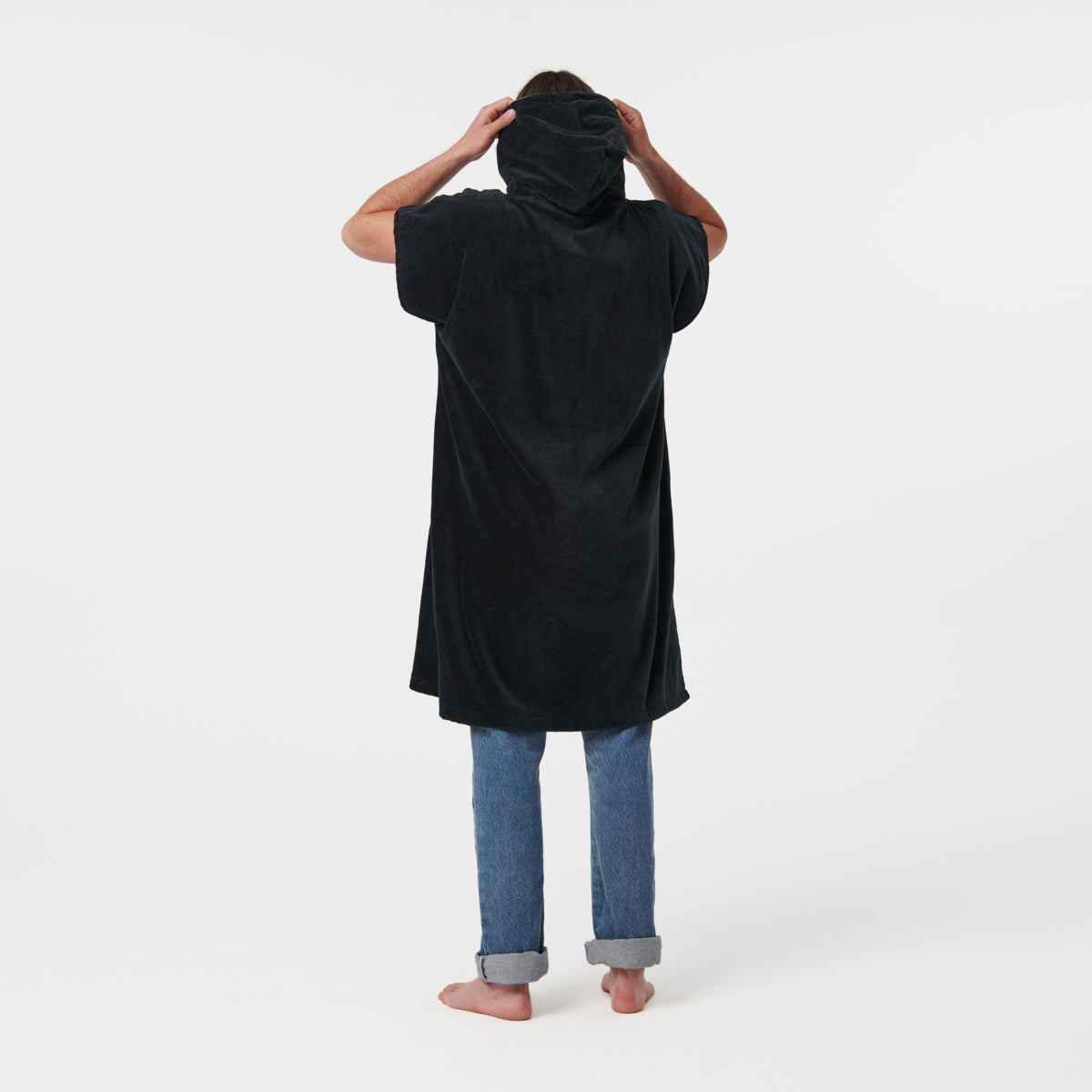 Black heavyweight cotton terry changing poncho with jeans, reverse view.