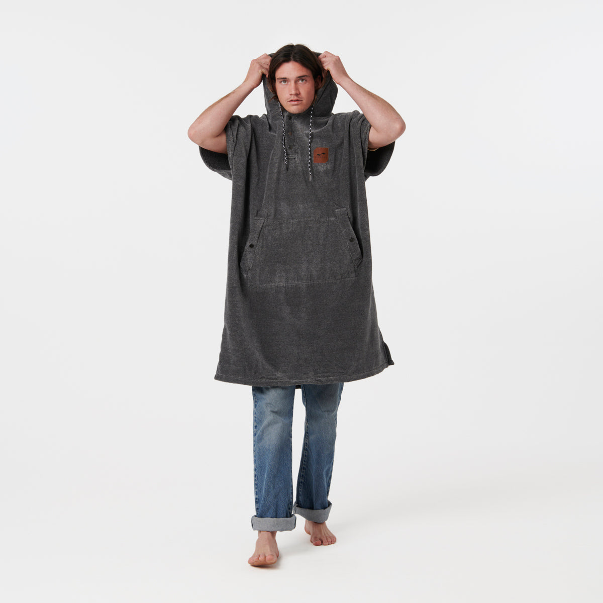 Dark hooded cotton terry towel poncho with heavyweight texture.