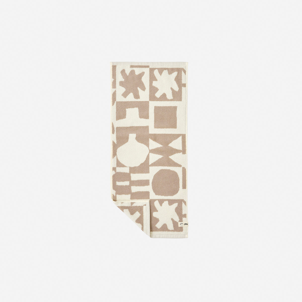 Cotton towels with beige and white geometric pattern, folded.