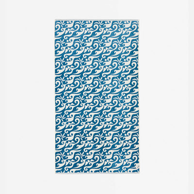 Blue and white rug with swirling wave pattern.