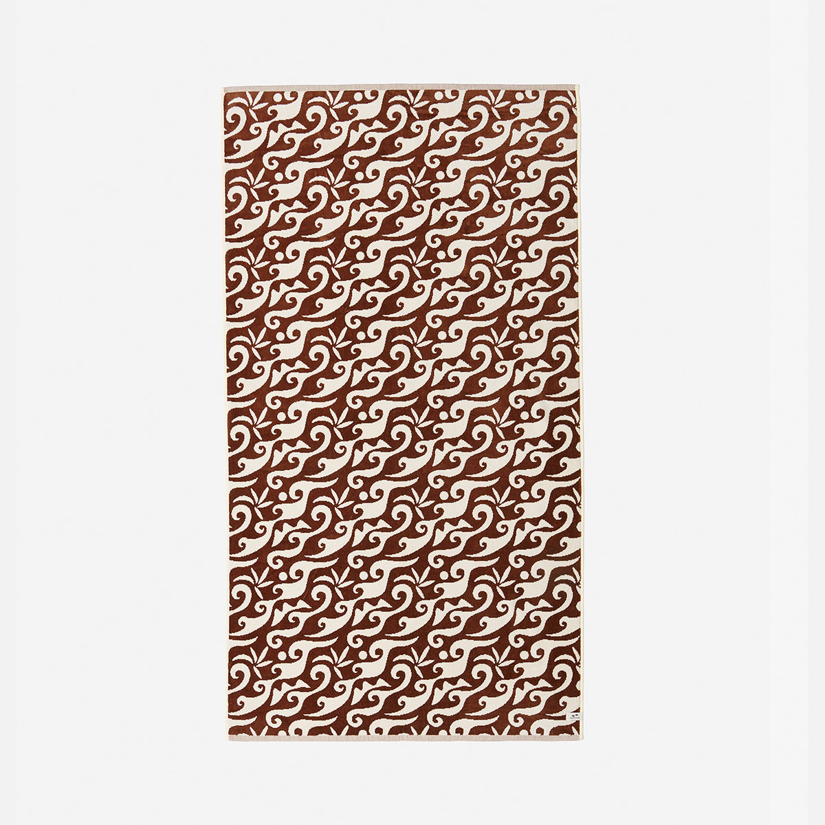 Rectangular mat with warm rust wave pattern on neutral background.
