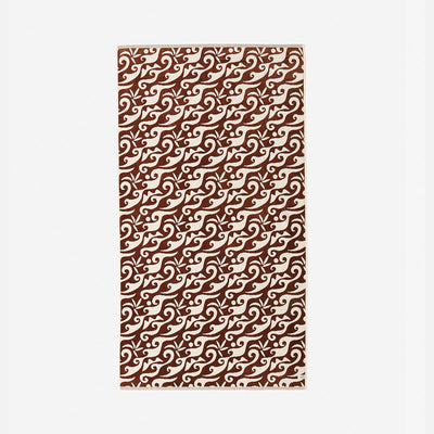 Rectangular mat with warm rust wave pattern on neutral background.