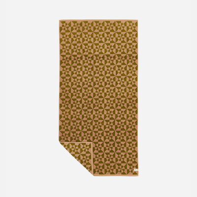 Bath towel with quilt-inspired star pattern on a light background.