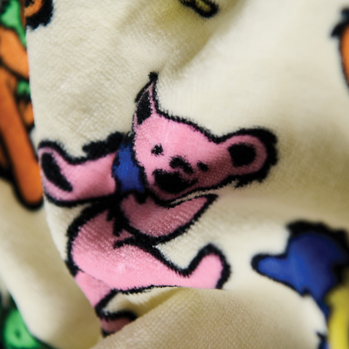 Terry tote bag with pink cartoon bear and colorful patterns, close-up view.