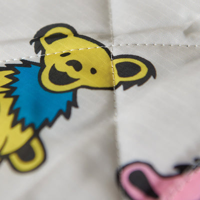 Blanket with yellow cartoon bear and blue collar pattern.