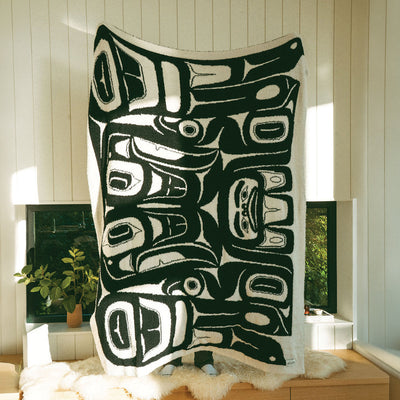 Recycled polyester throw blanket with bold abstract Tlingit-inspired pattern.