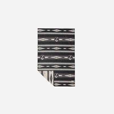 Blanket with black and white geometric diamond pattern and vintage-inspired design.