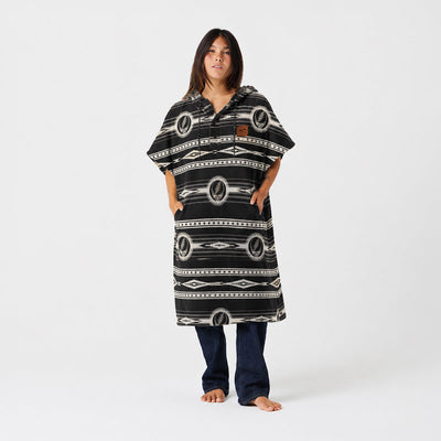 Patterned towel poncho with geometric design.