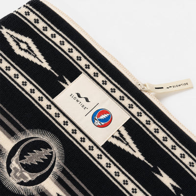 Terry pouch with black and white pattern and skull logo.