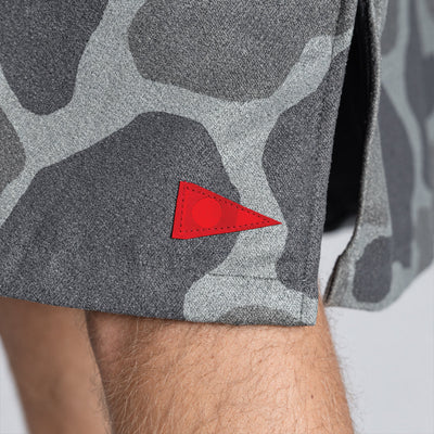 Gray camo shorts with red triangle patch near hem, quick-dry material.