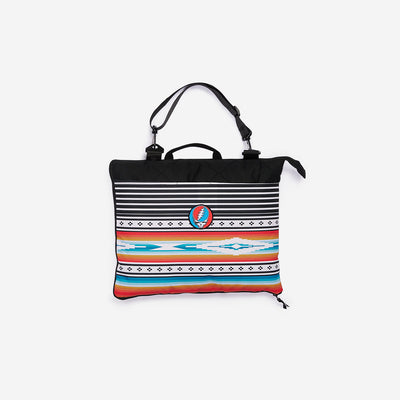 Patterned laptop bag with black handles and multicolor skull logo.