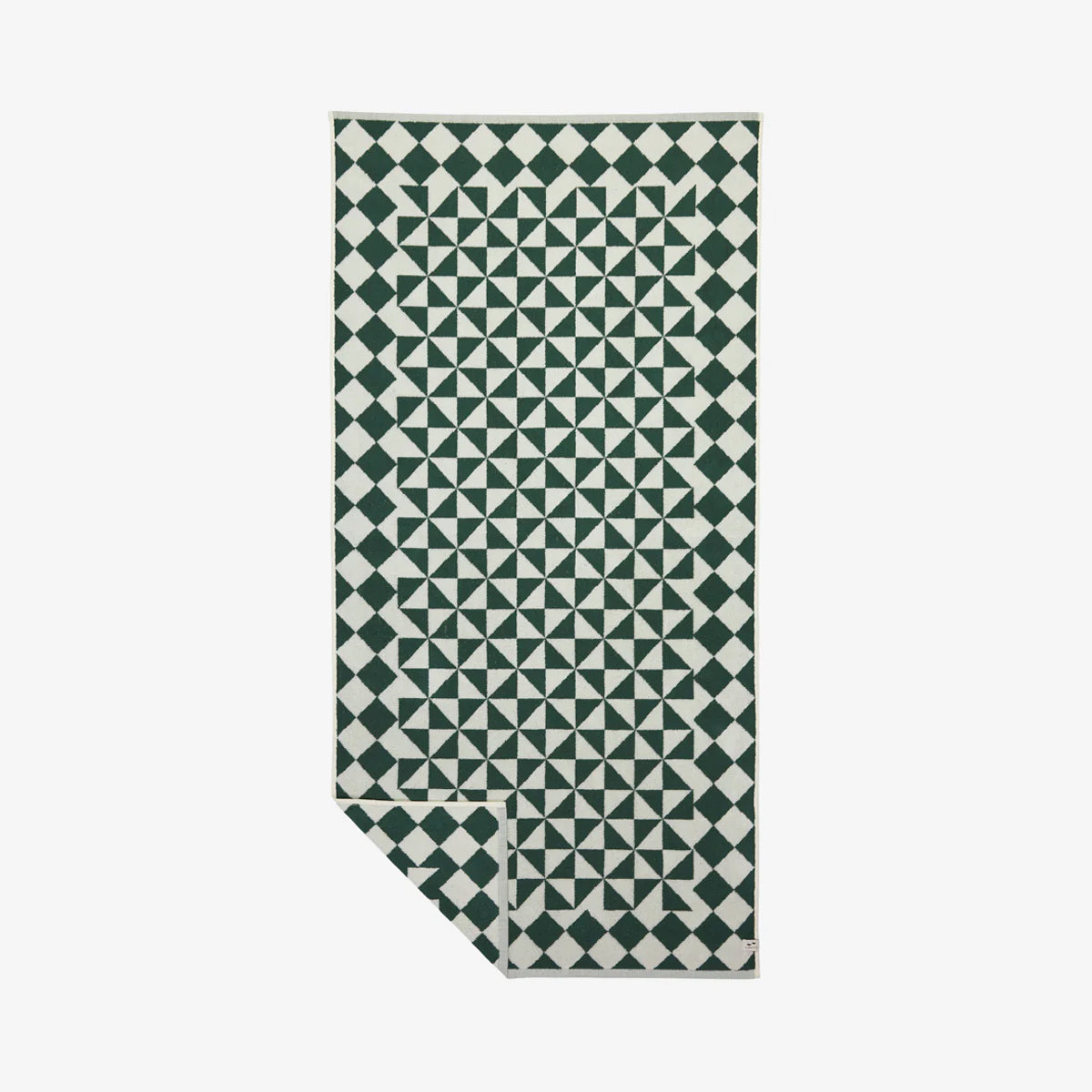 Bath towel with green and white diamond and triangle geometric pattern.