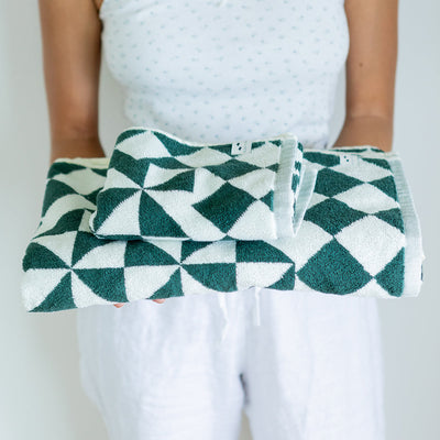 Hand towel with green and white geometric pattern, folded for display.
