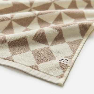 Bath towel, ultra-soft cotton, beige and brown geometric pattern.