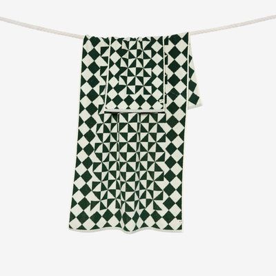 Hand towels with black and white geometric patterns hanging on a rope.