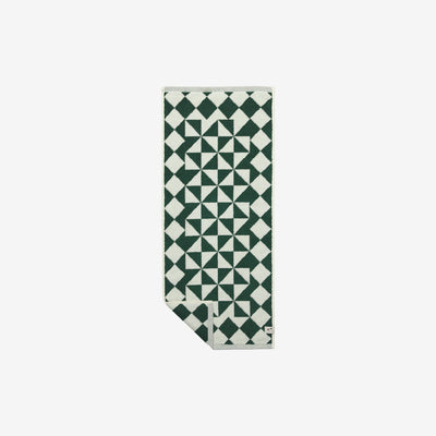 Hand towel, cotton, green and white geometric pattern, folded at one corner.