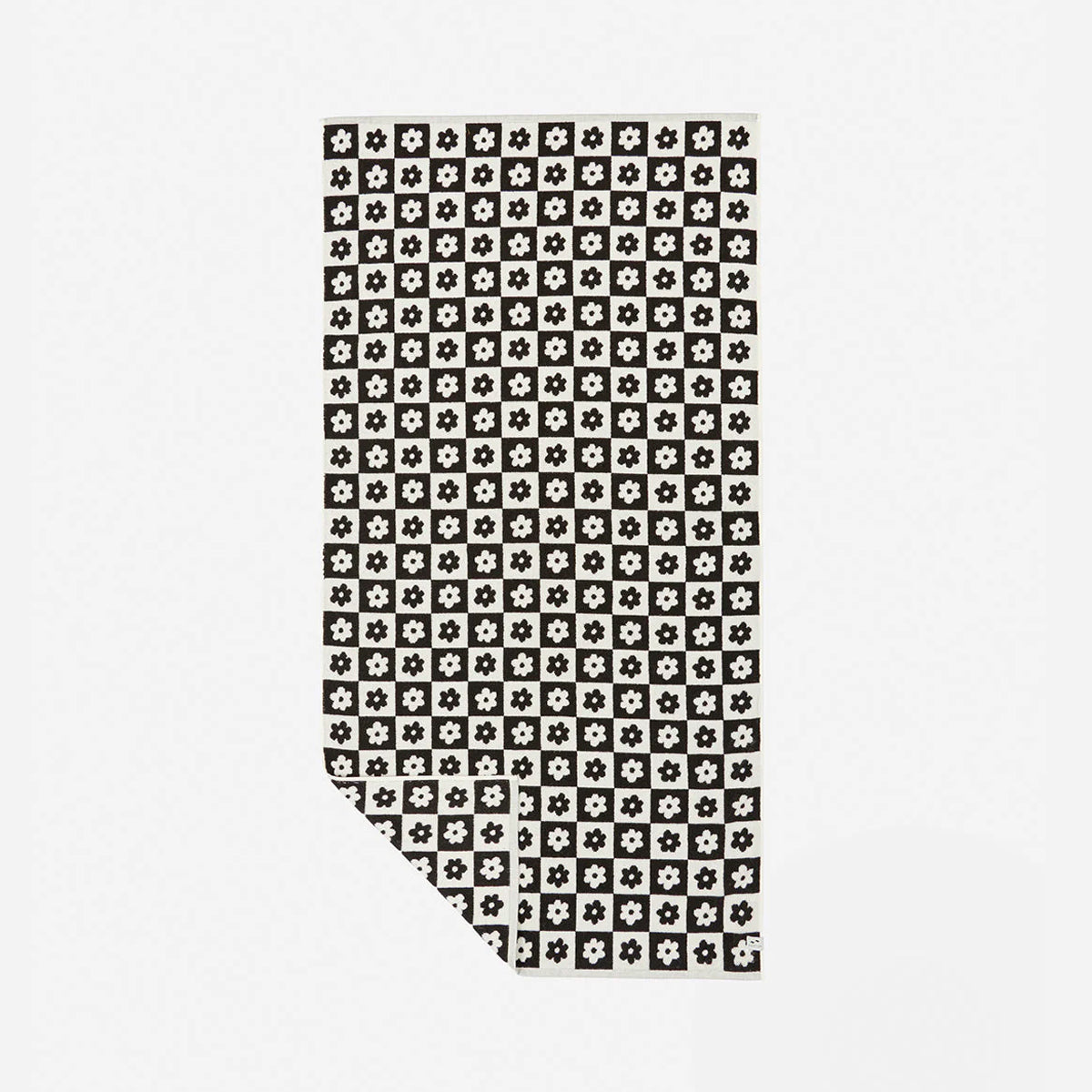 Quick dry towel with black and white geometric flower pattern, folded corner visible.