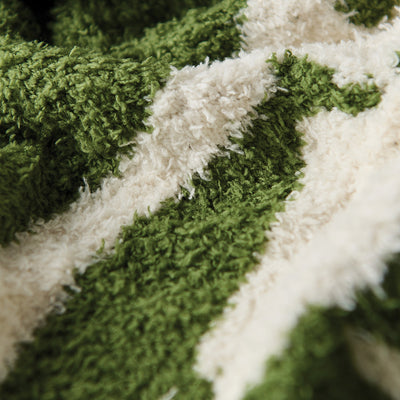 Cotton towel with soft green and white woven pattern, close-up texture view.