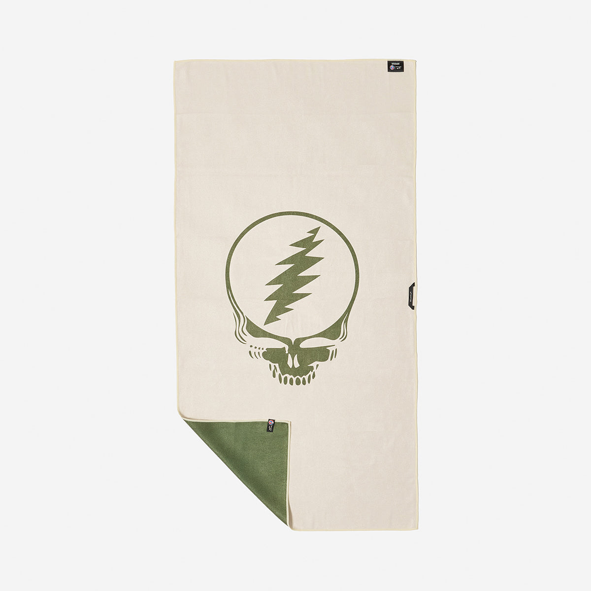 Beige quick-dry towel with green graphic, flipped corner shows green underside.