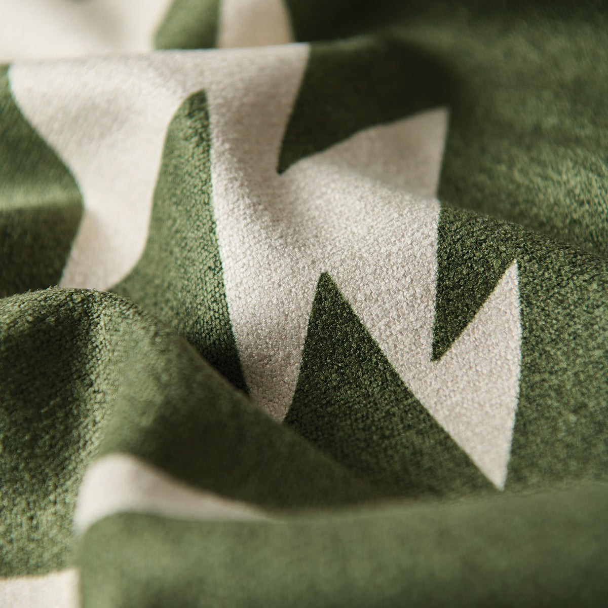 Quick-dry towel with green and white zigzag pattern and textured surface.