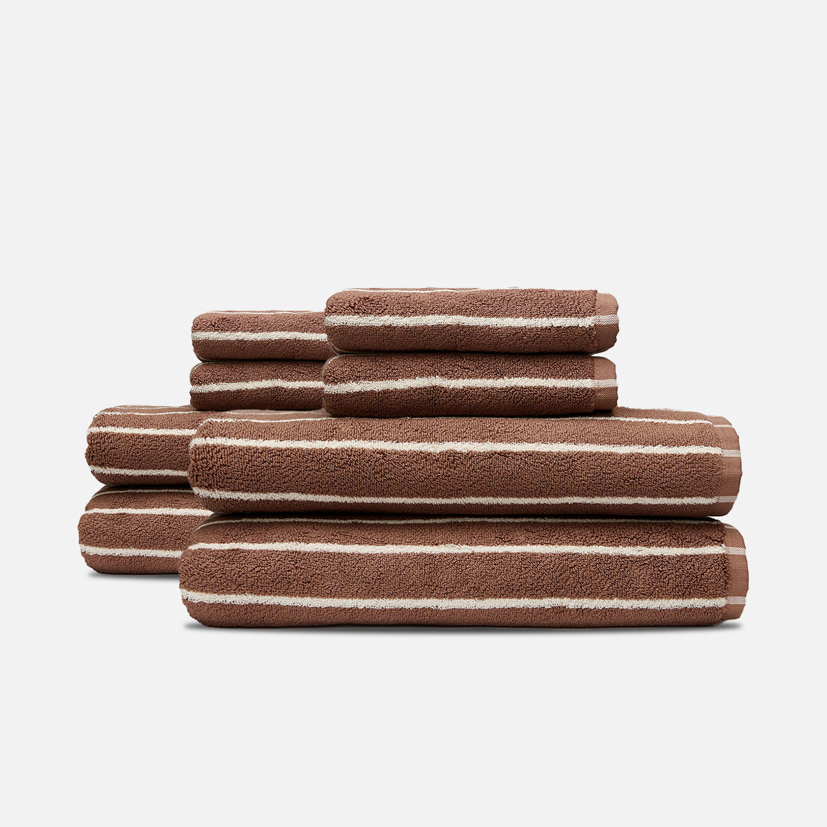 Striped plush bath towels with soft texture, stacked neatly.