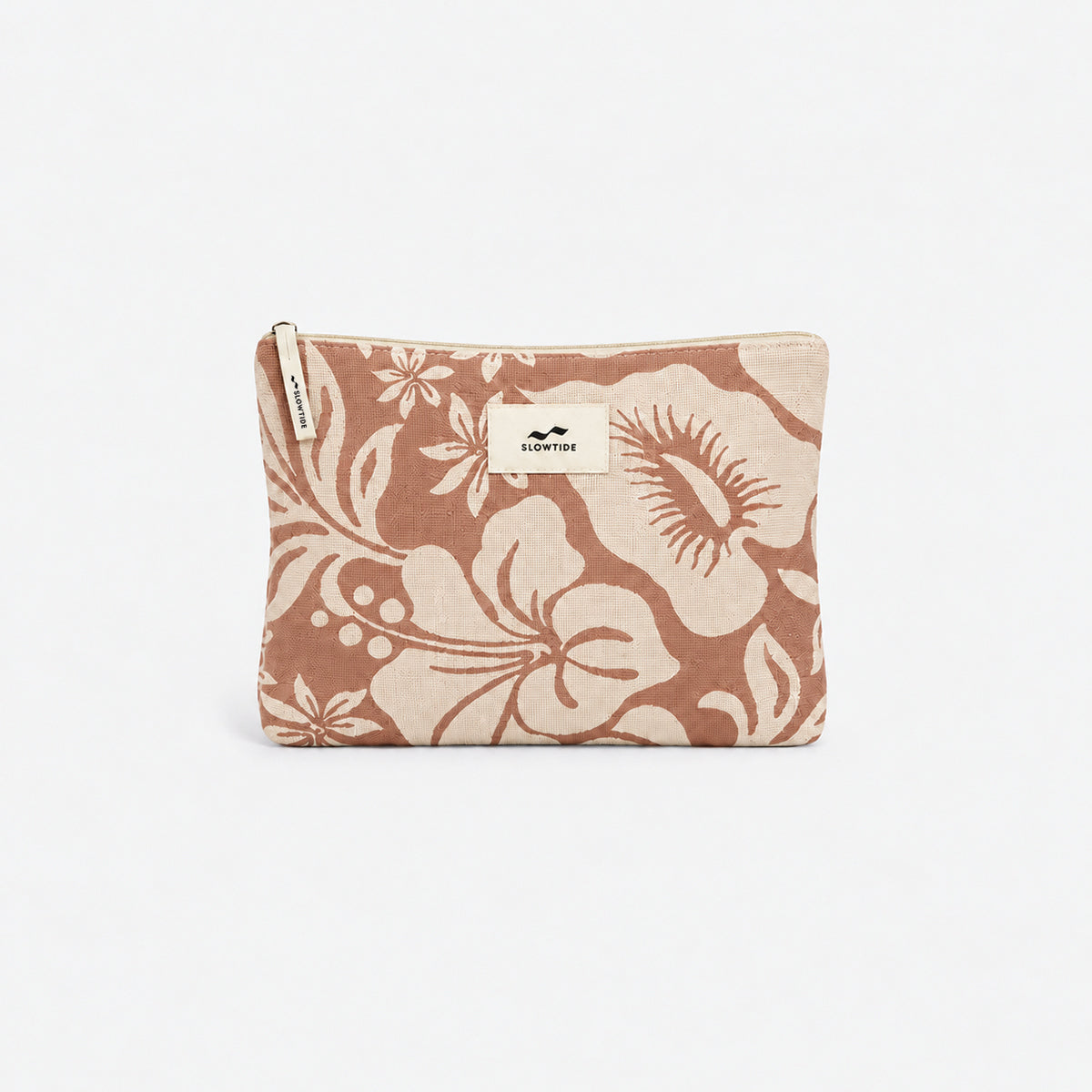 Tan pouch with white floral print and zipper top, suitable for carrying a quick dry towel.