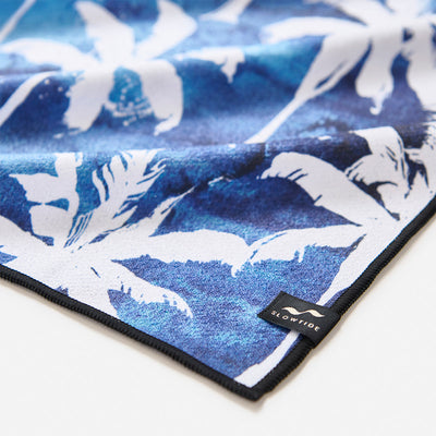 Beach towel, cotton, blue tie-dye with palm tree print.