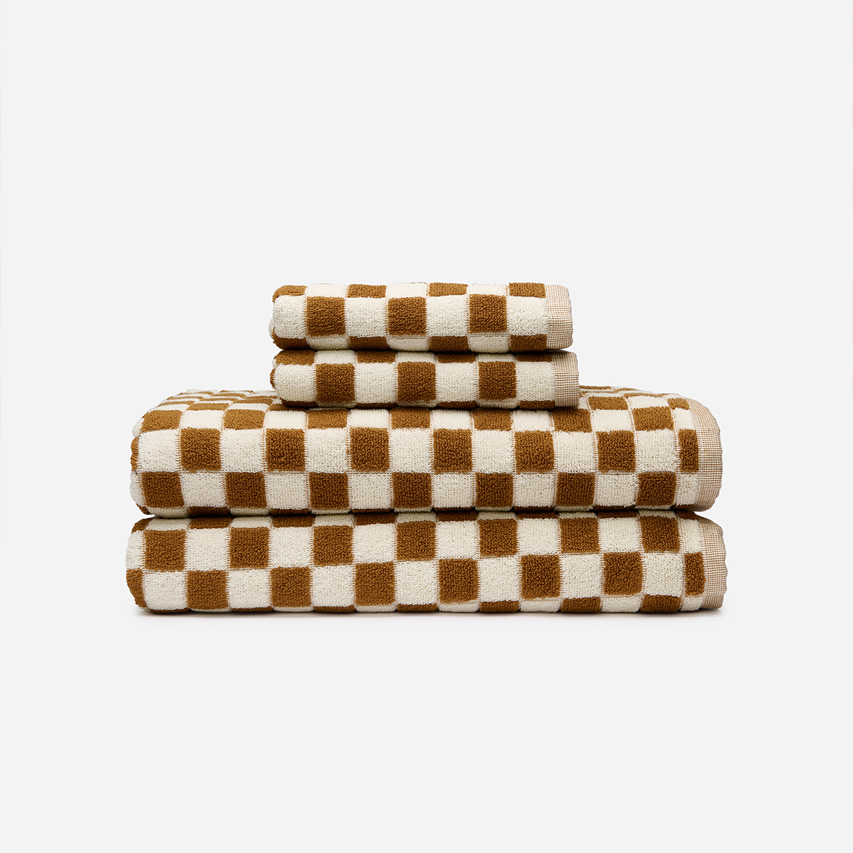 Absorbent towels with brown and white check pattern, neatly stacked.