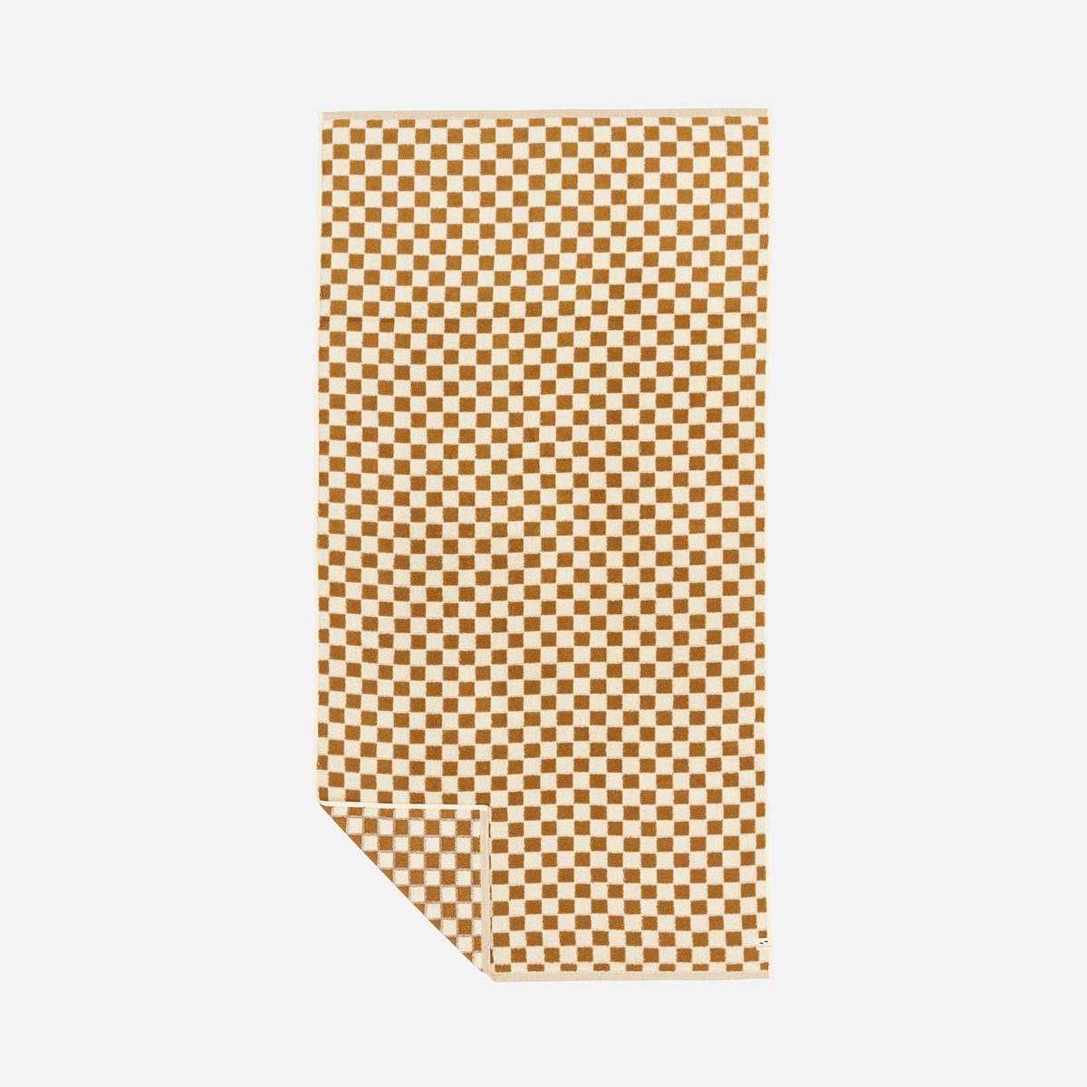 Absorbent towel, brown and white checkered pattern, one corner folded over.