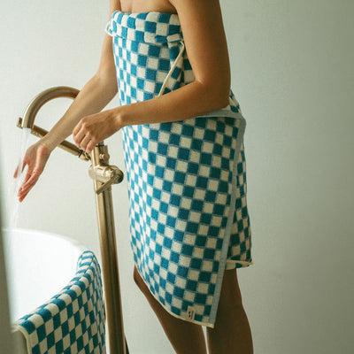 Bath towel wrap in absorbent blue and white checkered cotton.