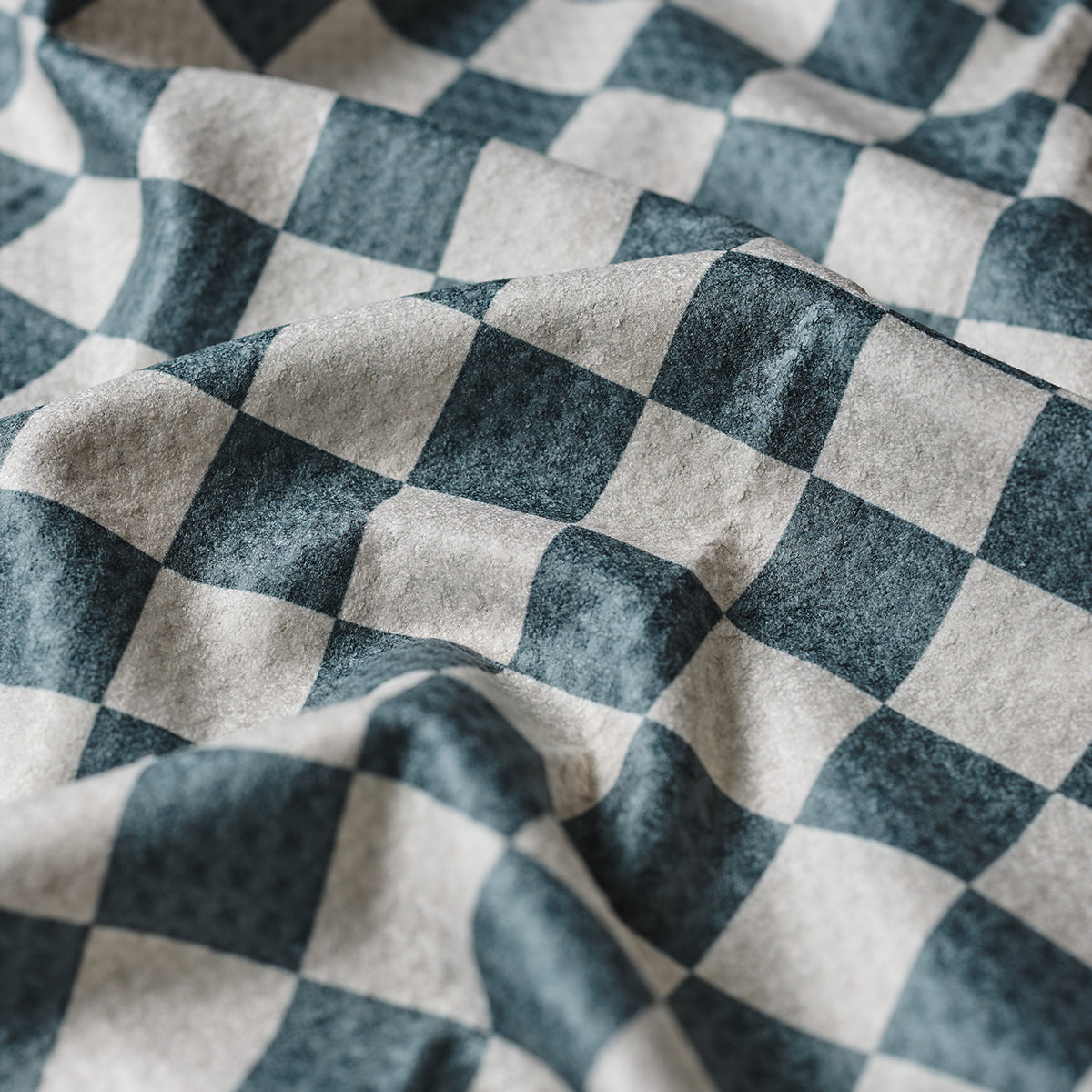 Kitchen towel with wavy black and white checkerboard pattern, cotton fabric.