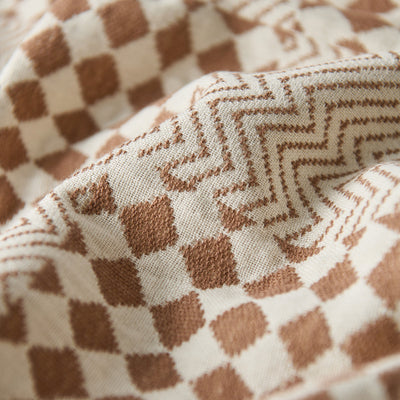 Cotton tote bag in a tan and white checkerboard and zigzag pattern.
