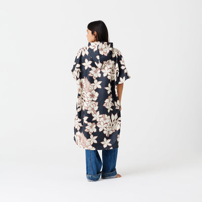 Floral print hooded poncho in quick-dry fabric with jeans.