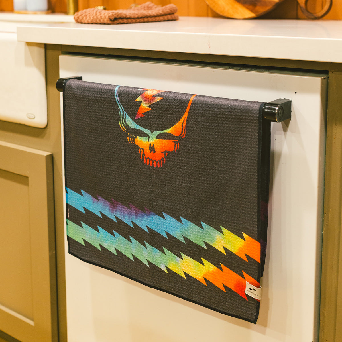 Black quick-dry towel with rainbow lightning bolts and stylized skull design.