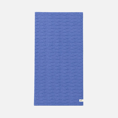 Cotton bath towel with plush texture and subtle wave pattern.