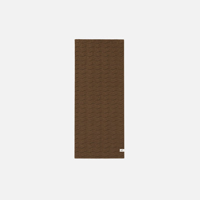 Cotton bathroom towel, brown with rectangular shape and small white tag on bottom right corner.